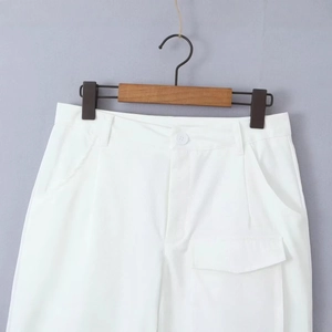 White cargo pants with large utility pockets and button closure in a minimalist style
