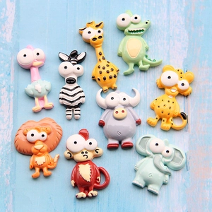 Set of nine cute resin cartoon animal charms including lion and giraffe on wood background
