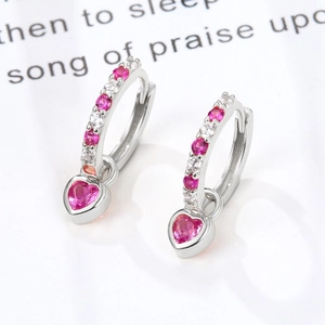 Macro shot of S925 silver heart earrings with pink zircon and white sparkling crystals