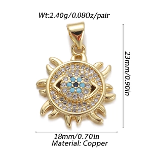 Detailed view of gold sun evil eye pendant with cubic zirconia and turquoise beads