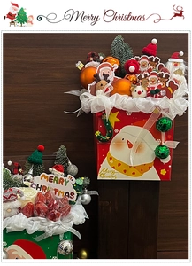 Detailed view of Christmas Santa gift bucket with mini ornaments and festive decorations