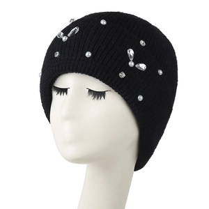 Women's black knit beanie with rhinestones and pearls on a white mannequin head