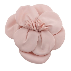 Detail shot of the handmade pink camellia fabric flower with layered soft petals