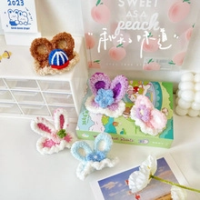 Detail of handmade crochet animal hair clips including bear and rabbit ear styles