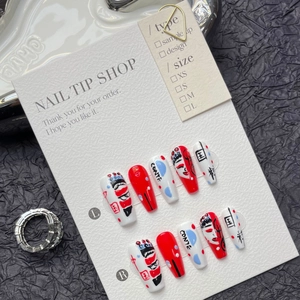 Macro detail of handmade Chinese opera face makeup press-on nails with red and white art