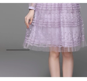 Detail of light purple layered mesh skirt with 3D floral embroidery and lace stitching