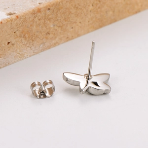 Detailed close-up of dragonfly silver earrings with matching butterfly back closures