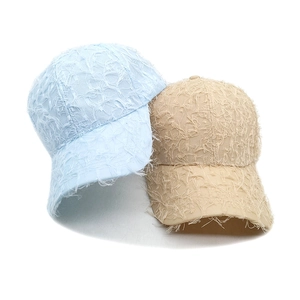 Frayed edge baseball caps in light blue and khaki featuring vintage distressed fabric texture