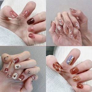 Sweet autumn press-on nails set with amber floral and cat patterns on short oval tips