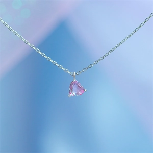 Close-up of pink heart-shaped rainbow zircon pendant with 18k gold-plated chain