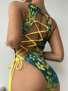 Detail of tropical floral one-piece swimsuit with crisscross back tie-up design