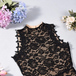 Detail of black lace bodysuit featuring floral patterns and delicate eyelash lace edges