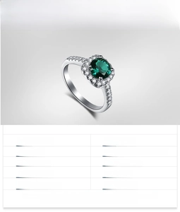 Macro shot of 925 sterling silver ring with round cut emerald and paved diamonds