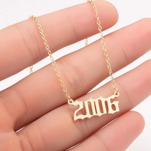 Detailed hand-held view of gold 2006 gothic year pendant necklace for women