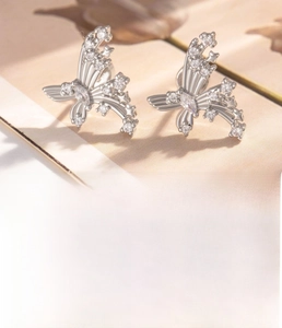 Macro detail of silver butterfly earrings with titanium steel pins and zircon stones