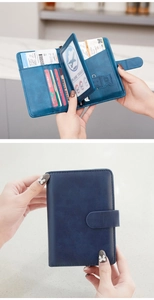 Detail view of RFID navy blue leather passport holder with aircraft gold hardware and SIM slots