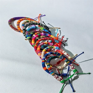 Detailed view of colorful Bohemian braided surf bracelets with adjustable knots on white background