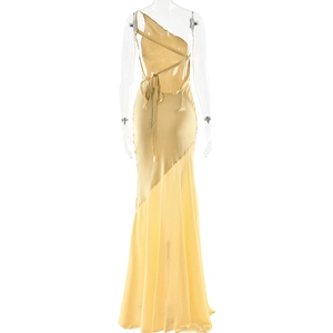 Detail of light yellow satin evening gown with back cut-out, lacing and asymmetrical hem