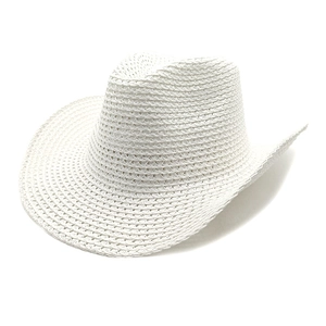 Detailed view of white hollow woven cowboy hat with wide brim and summer sun protection