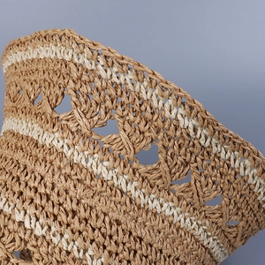 Close-up of hand-woven striped straw hat detail showing mesh pattern and fibers