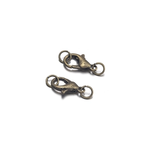 Close-up of antique bronze lobster clasps and jump rings for DIY jewelry making