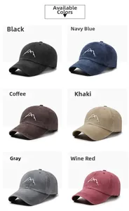 Detail view of vintage washed cotton baseball caps with mountain embroidery in six colors