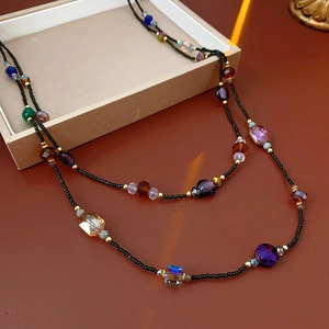 Macro view of multi-layer beaded necklace featuring colorful faceted stones and seed beads