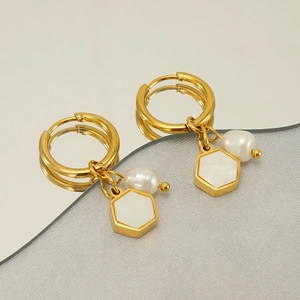 Modern gold stainless steel hexagonal earrings with white pearl pendants and mirror reflection