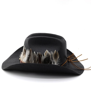 Detail of black straw cowboy hat featuring authentic natural feathers and brown leather band