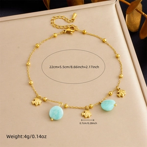 Gold plated stainless steel anklet featuring small fish charms and light blue oval gemstones