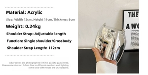 Detail of silver mirror acrylic hip-shaped mini bag with adjustable shoulder strap