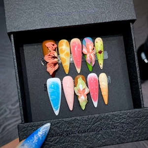 Macro detail of luxury 3D floral stiletto press-on nails with realistic water drop effects
