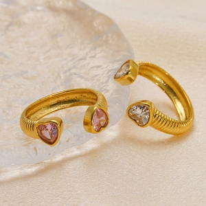 18K gold-plated adjustable heart zircon rings on textured glass and champagne silk backdrop