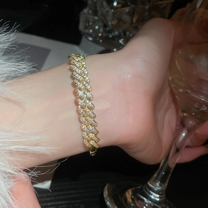 Close-up of 18k gold plated bracelet with pave cubic zirconia on a female wrist