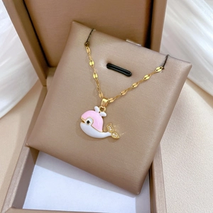 Detail of pink enamel whale pendant with zircon stones on gold titanium steel chain