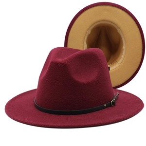 Close-up of burgundy fedora hat featuring black leather belt and khaki contrast brim