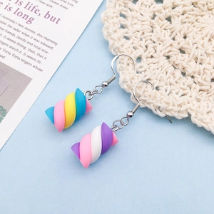 Close-up of rainbow marshmallow resin earrings with S925 silver hooks on blue texture