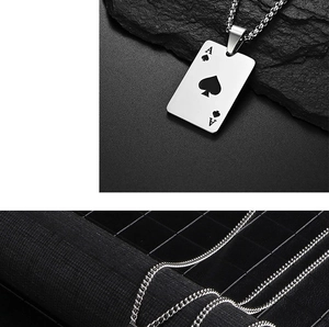 Macro detail of silver ace of spades poker pendant with black engraved spade and metal chain