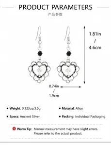 Detail view of retro hollow heart earrings with cross pattern and black bead accent