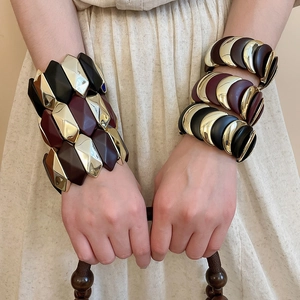 Close-up of geometric wide elastic bracelet with moon patchwork design on wrist