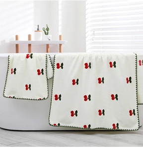 Plush coral fleece towel set with cherry embroidery and green wavy crochet edges