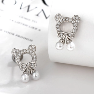 Silver bear cartilage earrings with bow, sparkling cubic zirconia and pearl pendants