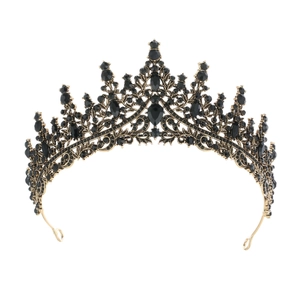Close-up of vintage black gold crown with intricate metalwork and black rhinestones