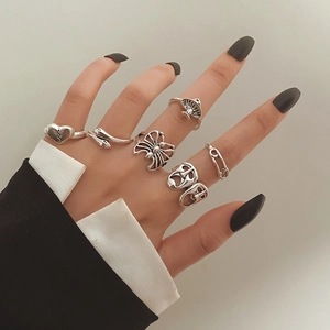 Detail shot of vintage silver rings featuring skull, spider, and snake motifs on hand