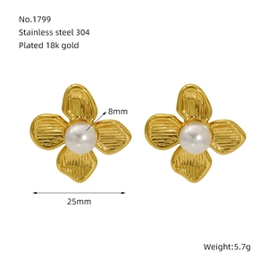 Detail of 18K gold plated flower stud earrings with 8mm pearl inlay on white background