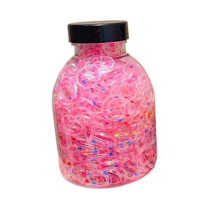 High elastic pink children hair rubber bands with colorful rainbow accents in a jar