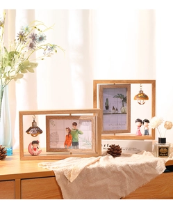 Detail of 6-inch rotating wooden photo frame with interior cartoon figure and light