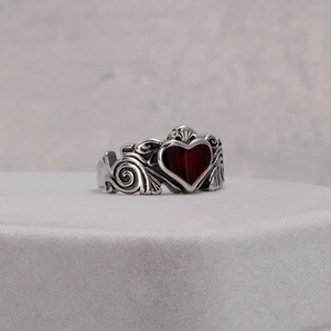 Fashionable titanium steel ring with a red heart enamel inlay and retro scroll patterns