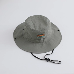 Close-up of waterproof nylon sun hat with Better Self logo and adjustable chin strap