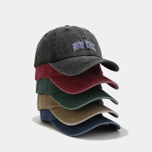 Detailed stack of vintage washed cotton baseball caps with New York embroidery in 5 colors